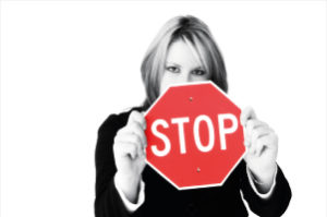 Business woman holding a stop sign